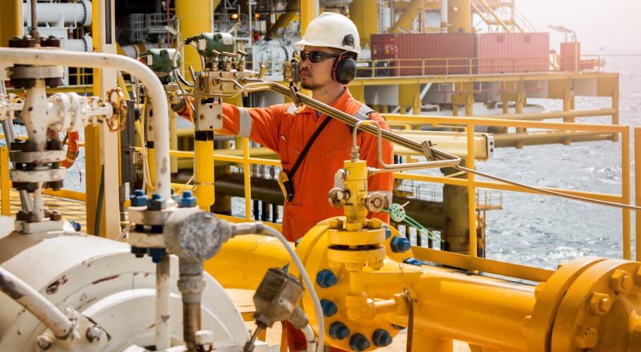 operator recording operation of oil and gas process at oil and rig plant, offshore oil and gas industry, offshore oil and rig in the sea, operator monitor production process, routine daily record.